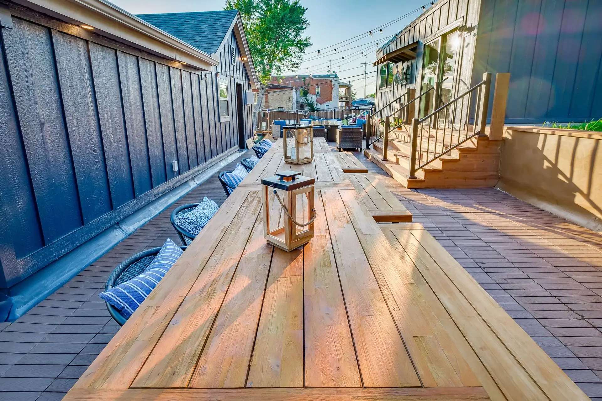 Long rooftop dining table with lanterns