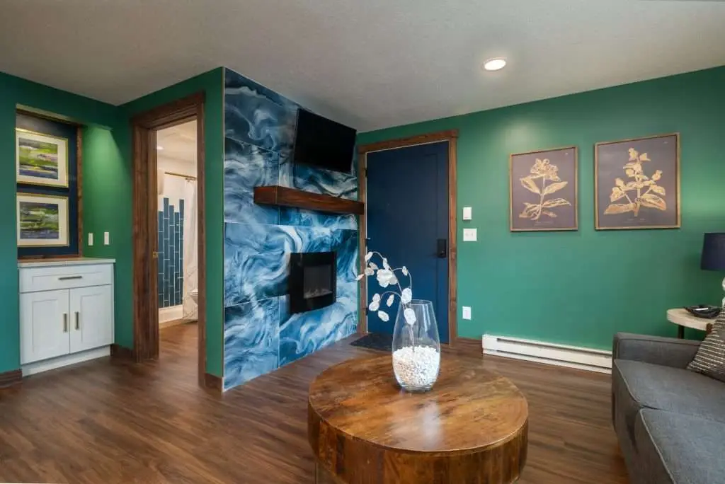 Living room with blue stone fireplace and round coffee table