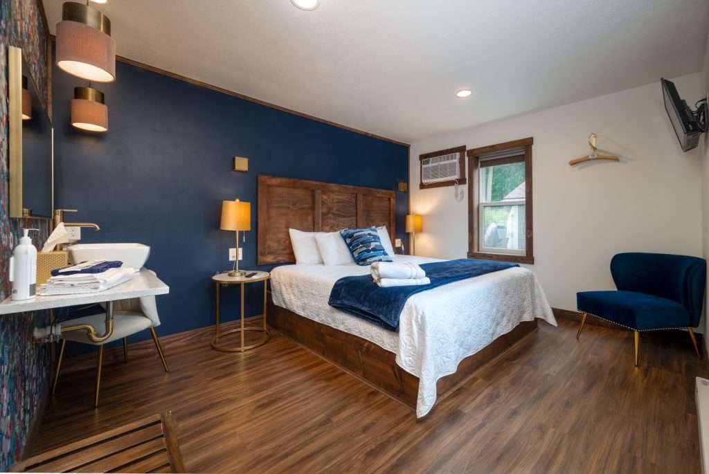 King bedroom with vanity and blue chair